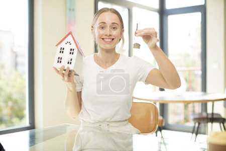 Photo for Model holding a house. home concept - Royalty Free Image