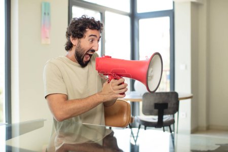 Photo for Young crazy man with a megaphone - Royalty Free Image