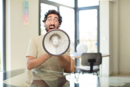 Photo for Young crazy man with a megaphone - Royalty Free Image