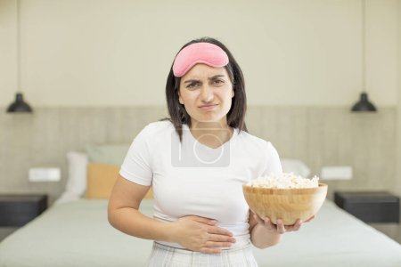 Photo for Young woman with popcorn at home - Royalty Free Image