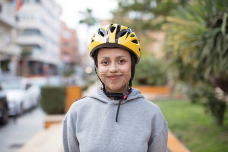 Photo for Hispanic woman with a bike helemet - Royalty Free Image
