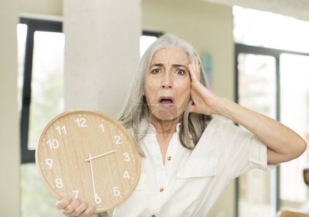 Photo for Senior woman with a clock - Royalty Free Image
