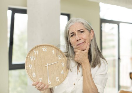 Photo for Senior woman with a clock - Royalty Free Image