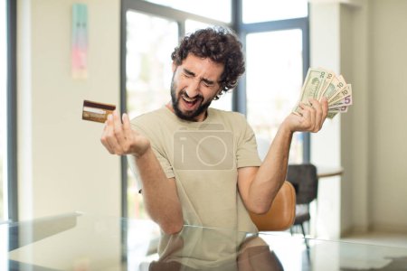 Photo for Bearded hispanic man shopping with a credit card - Royalty Free Image