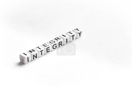 Photo for Word Integrity on white background. This term means the quality of being honest and having strong moral principles. It describes personal moral uprightness. - Royalty Free Image