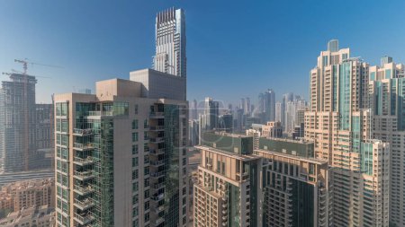 Photo for Panorama of downtown Dubai city aerial timelapse. Urban skyline with modern skyscrapers and towers construction site from above - Royalty Free Image
