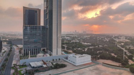Photo for Sunrise in Dubai International Financial district transition timelapse. Aerial view of business office towers at morning. Skyscrapers with hotels near downtown - Royalty Free Image