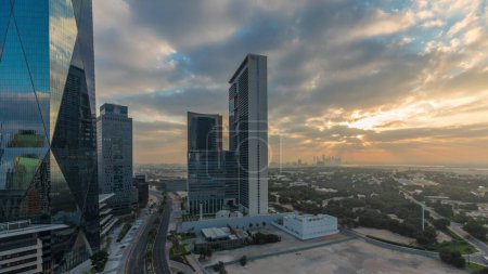 Foto de Salida del sol en el distrito financiero internacional de Dubai timelapse transición. Vista aérea panorámica de las torres de oficinas de negocios por la mañana. Rascacielos con hoteles y centros comerciales cerca del centro - Imagen libre de derechos
