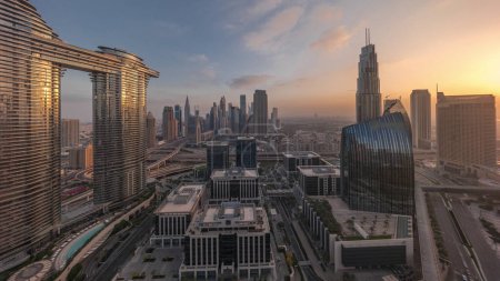 Photo for Futuristic Dubai Downtown and finansial district skyline aerial timelapse during all day from sunrise to sunset. Many towers and skyscrapers with shadows moving fast - Royalty Free Image