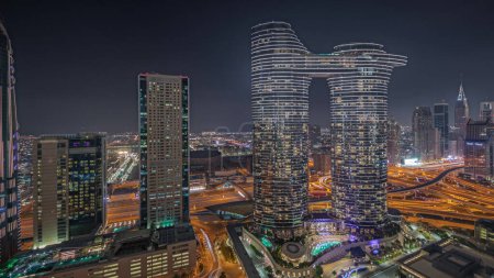 Photo for Panorama showing futuristic Dubai Downtown and finansial district skyline aerial night timelapse. Many illuminated towers and skyscrapers with traffic on streets - Royalty Free Image