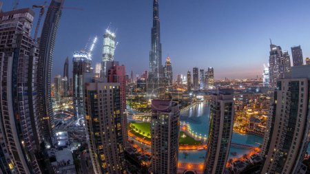 Photo for Panorama of Dubai Downtown cityscape with tallest skyscrapers around aerial night to day transition timelapse. Construction site of new towers and busy roads with traffic from above - Royalty Free Image