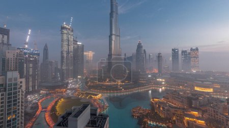 Foto de Aerial view of Dubai city early morning during fog night to day transition . Futuristic city panoramic skyline with skyscrapers and towers from above - Imagen libre de derechos