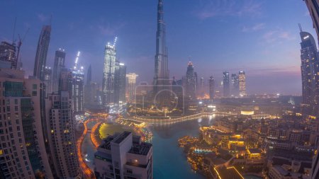 Photo for Aerial view of Dubai city early morning during fog night to day transition . Futuristic city skyline with skyscrapers and towers during sunrise from above - Royalty Free Image