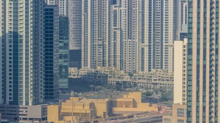 Photo for Dubai's business bay towers aerial morning . Rooftop view of many skyscrapers and new buildings under construction - Royalty Free Image