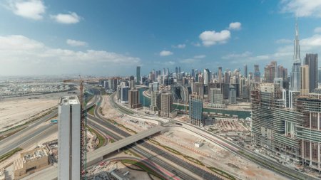 Foto de Panorama showing skyline of Dubai with business bay and downtown district . Aerial view of many modern skyscrapers with cloudy blue sky. United Arab Emirates. - Imagen libre de derechos