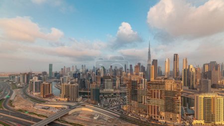 Photo for Panoramic skyline of Dubai with business bay canal and downtown district morning . Aerial view of many modern skyscrapers with sun reflections during sunrise. United Arab Emirates. - Royalty Free Image