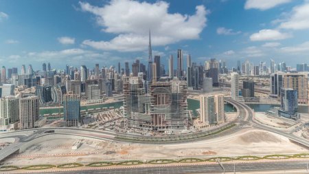 Foto de Panorama showing skyline of Dubai downtown district with business bay . Aerial view of many modern skyscrapers with cloudy blue sky. United Arab Emirates. - Imagen libre de derechos