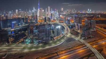 Photo for Panoramic skyline of Dubai with business bay and downtown with financial district night . Aerial view of many modern skyscrapers and busy traffic on al khail road. United Arab Emirates. - Royalty Free Image