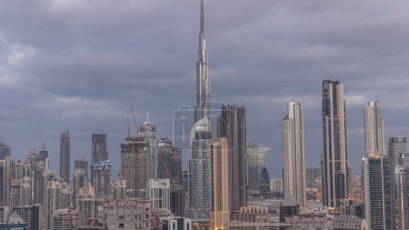 Foto de Panoramic skyline of Dubai downtown district with business bay night to day transition . Aerial view of many modern skyscrapers before sunrise. United Arab Emirates. - Imagen libre de derechos