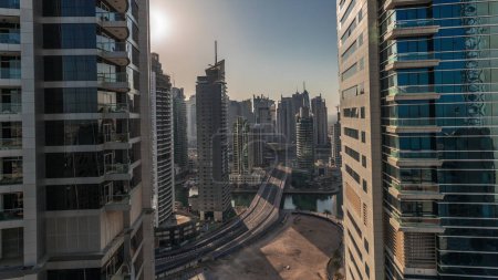 Téléchargez les photos : Panorama showing Dubai Marina and JBR area and the famous Ferris Wheel aerial  and golden sand beaches in the Persian Gulf during sunrise - en image libre de droit