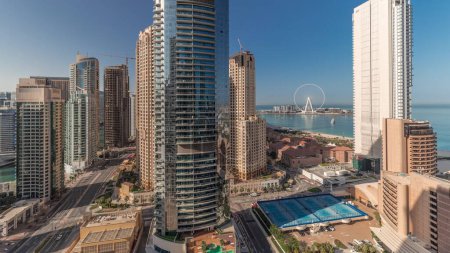 Photo for Panorama showing Dubai Marina and JBR area and the famous Ferris Wheel aerial  and golden sand beaches in the Persian Gulf at the morning - Royalty Free Image