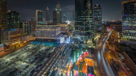 Photo for Panorama showing Dubai International Financial district night . Aerial view of business office towers. Illuminated skyscrapers with hotels and shopping malls near downtown - Royalty Free Image