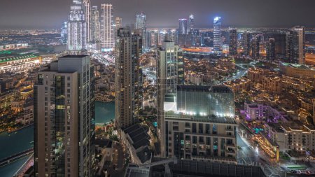 Téléchargez les photos : Panorama showing aerial view of a big futuristic city night . Business bay and Downtown district with many skyscrapers and traditional houses, Dubai, United Arab Emirates skyline. - en image libre de droit