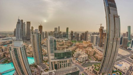 Foto de Aerial panorama with sunrise over big futuristic city . Business bay and Downtown district with skyscrapers and traditional houses, Dubai, United Arab Emirates skyline. - Imagen libre de derechos