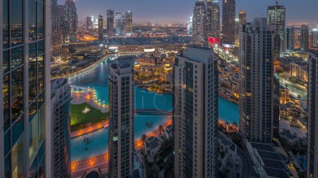 Foto de Dubai downtown with fountains and modern futuristic architecture aerial night to day transition . Panoramic view to skyscrapers with old town and shopping mall - Imagen libre de derechos