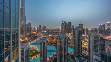 Photo for Dubai downtown with fountains and modern futuristic architecture aerial night to day transition  before sunrise. Panoramic view to skyscrapers with old town and shopping mall - Royalty Free Image
