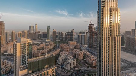Téléchargez les photos : Panorama showing aerial panoramic skyline of a big futuristic city during sunset . Business bay and Downtown district with skyscrapers and traditional houses, Dubai, United Arab Emirates - en image libre de droit