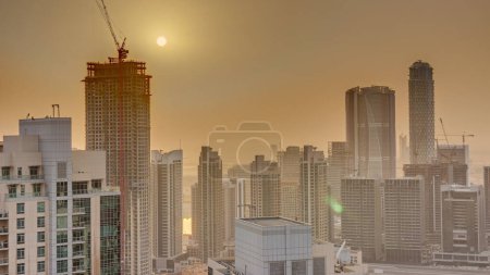 Foto de Aerial sunrise over big futuristic city . Business bay and Downtown district with skyscrapers, Dubai, United Arab Emirates skyline. - Imagen libre de derechos