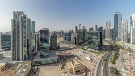 Téléchargez les photos : Panorama showing Bay Avenue with modern towers residential development in Business Bay aerial , Dubai, UAE. Skyscrapers with big parking lot and construction site - en image libre de droit