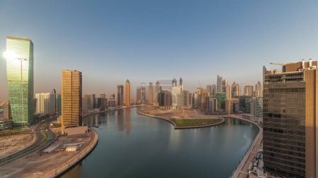 Téléchargez les photos : Cityscape skyscrapers of Dubai Business Bay with water canal aerial panoramic  during sunrise. Modern skyline with sun reflected from towers and waterfront. A center of international business - en image libre de droit