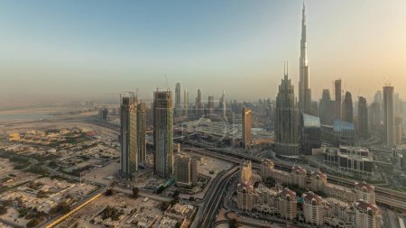 Photo for Panorama showing aerial view of tallest towers in Dubai Downtown skyline and highway  before sunset. Financial district and business area in smart urban city. Skyscraper and high-rise buildings - Royalty Free Image