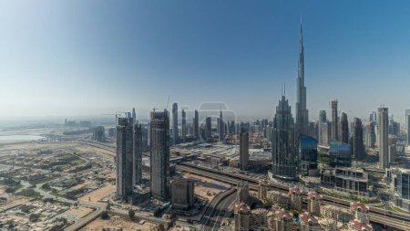 Téléchargez les photos : Panorama showing aerial view of tallest towers in Dubai Downtown skyline and highway . Financial district and business area in smart urban city. Skyscraper and high-rise buildings - en image libre de droit