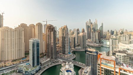 Téléchargez les photos : Panorama showing various skyscrapers in tallest recidential block in Dubai Marina aerial  with artificial canal. Many towers and yachts - en image libre de droit