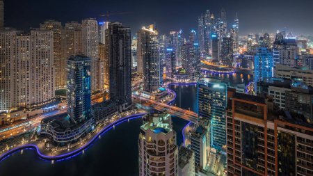 Photo for Panorama showing various skyscrapers in tallest recidential block in Dubai Marina and JDR district aerial night  with artificial canal. Many towers and yachts - Royalty Free Image