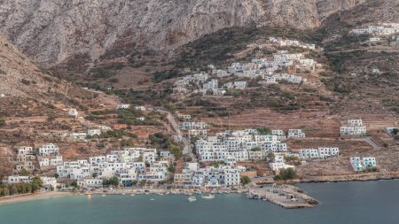 Photo for Amorgos island aerial day to night transition timelapse from above after sunset. Traditional Greece - illuminated white houses on hills and turquoise sea, Cyclades - Royalty Free Image