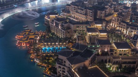 Photo for Aerial view to Old Town Island from above night timelapse with swimming pool. Dubai downtown with fountains area near mall and souk - Royalty Free Image