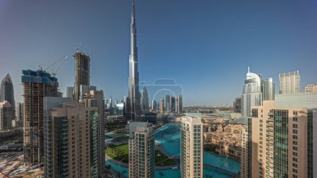 Photo for Panorama showing Dubai Downtown skyline cityscape with tallest skyscrapers around aerial timelapse. Construction site of new towers and busy roads with traffic from above - Royalty Free Image
