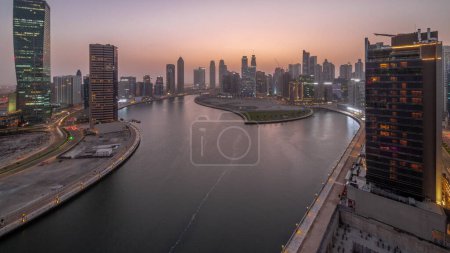 Photo for Cityscape of skyscrapers in Dubai Business Bay with water canal aerial day to night transition panoramic. Modern skyline with towers and waterfront after sunset. A center of international business - Royalty Free Image