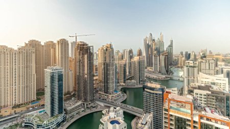 Photo for Panorama showing various skyscrapers in tallest recidential block in Dubai Marina aerial timelapse with artificial canal. Many towers and yachts - Royalty Free Image
