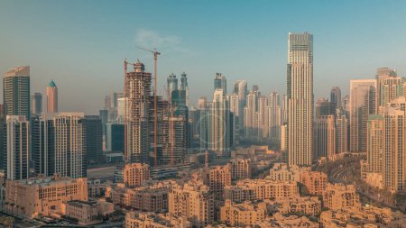 Photo for Dubai's business bay towers aerial morning . Rooftop view of some skyscrapers and new buildings under construction during sunrise - Royalty Free Image