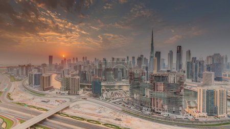 Photo for Skyline with modern architecture of Dubai business bay towers and downtown at sunset . Aerial panoramic view with canal and construction site - Royalty Free Image