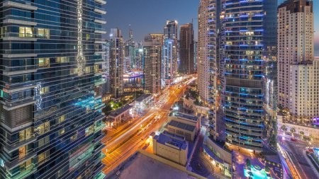 Téléchargez les photos : Panoramic view of the Dubai Marina and JBR area aerial day to night transition . Traffic on the road after sunset - en image libre de droit