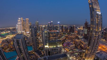 Foto de Aerial panorama of a big futuristic city day to night transition . Business bay and Downtown district with many skyscrapers and traditional houses, Dubai, United Arab Emirates skyline. - Imagen libre de derechos
