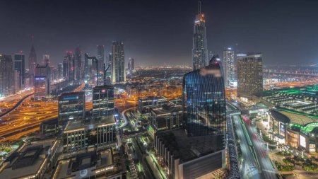 Photo for Futuristic Dubai Downtown and finansial district skyline aerial night . Many illuminated towers and skyscrapers with traffic on streets with lights turning off - Royalty Free Image