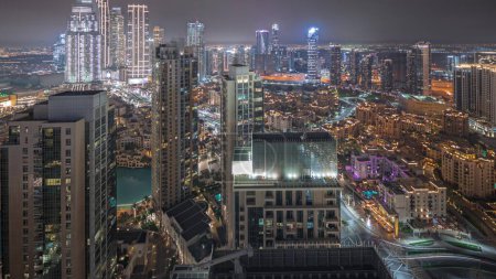 Foto de Panorama showing aerial view of a big futuristic city night . Business bay and Downtown district with many skyscrapers and traditional houses, Dubai, United Arab Emirates skyline. - Imagen libre de derechos