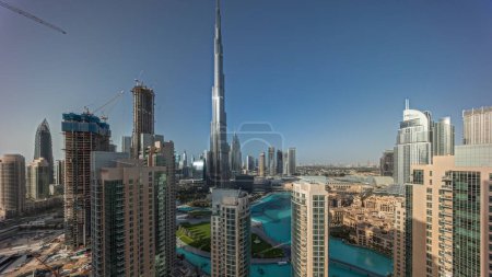 Foto de Panorama showing Dubai Downtown skyline cityscape with tallest skyscrapers around aerial . Construction site of new towers and busy roads with traffic from above - Imagen libre de derechos